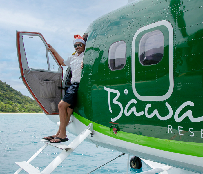 offers-green-seaplane-smiling-pilot-santa-hat-700x600px