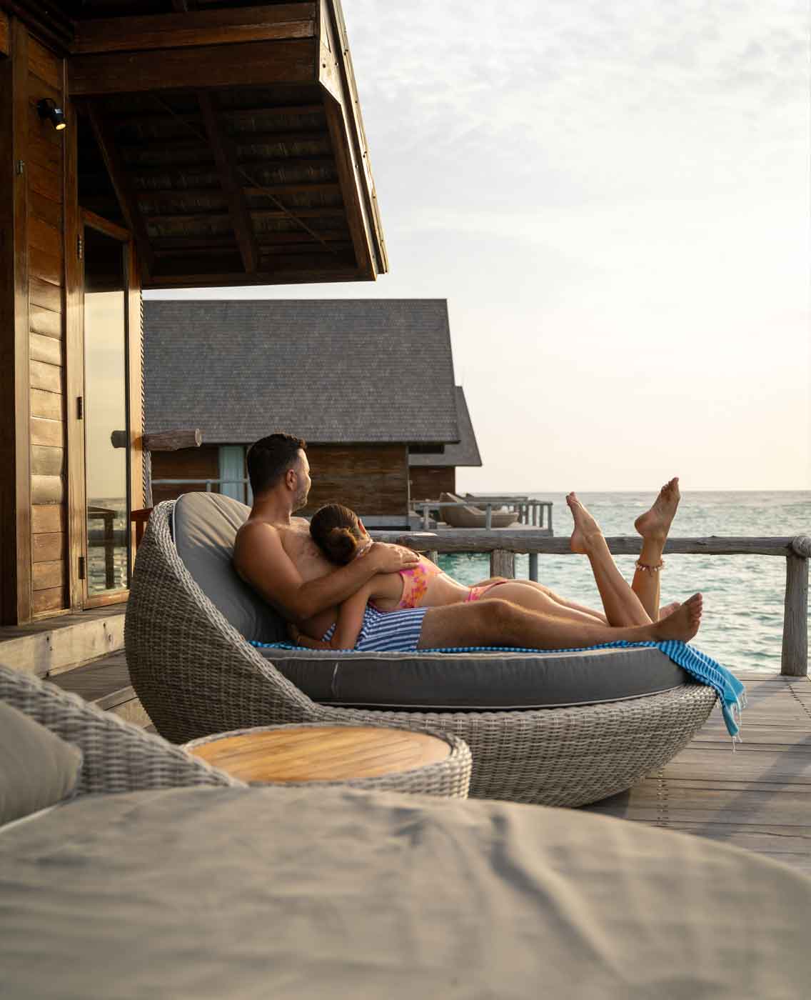 honeymoon-male-female-couple-sun-lounger-romantic-overwater-suite